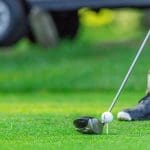 A golfer at Tullymore Golf Resort in Canadian Lakes Michigan tees up